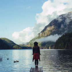 Woman standing by river with Body Dysmorphic Disorder