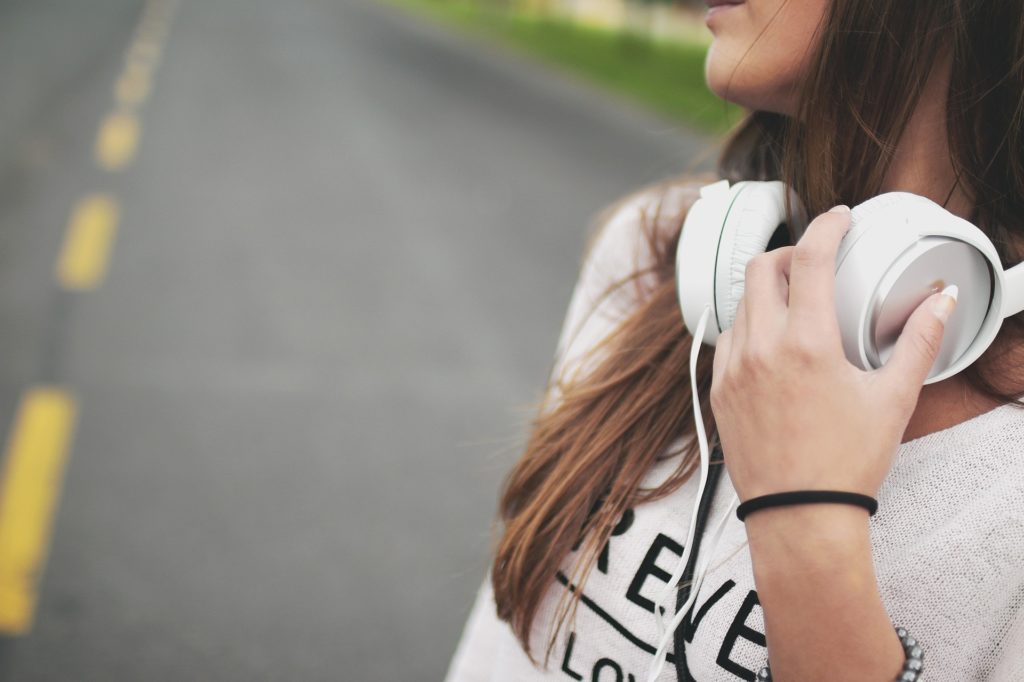 Adolescent girl listening to headphones