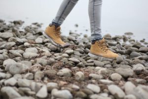 Woman struggling with relapse walking on rocks