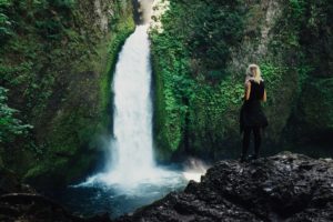 Woman near waterfall