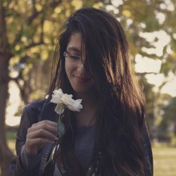 Woman smelling a flower and using Mindfulness in Eating Disorder Recovery
