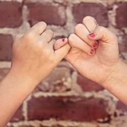 Friends showing a Pinky Swear
