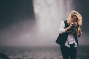 Woman near waterfall