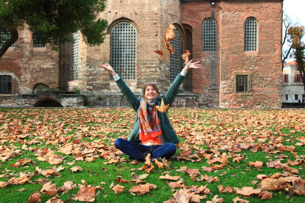Girl tossing leaves in the air celebrating Recovery from an Eating Disorder