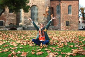 Girl tossing leaves while in Eating Disorder Treatment