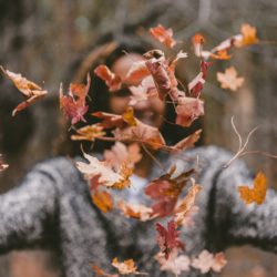 Woman throwing leaves to Focus on Life