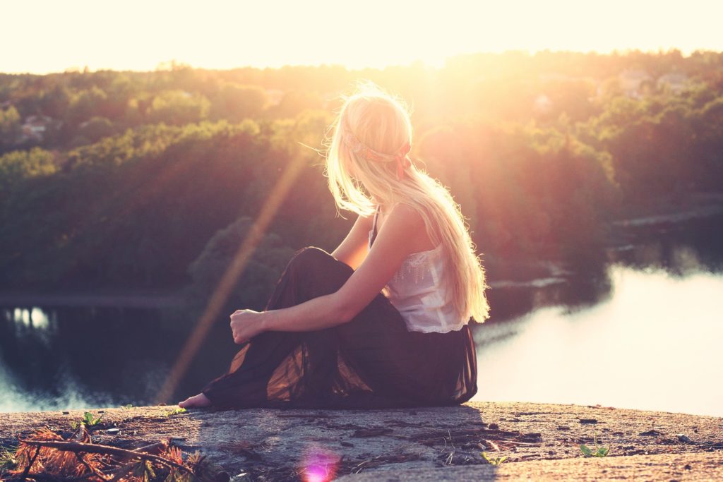 Woman with binge eating disorder seated by the river