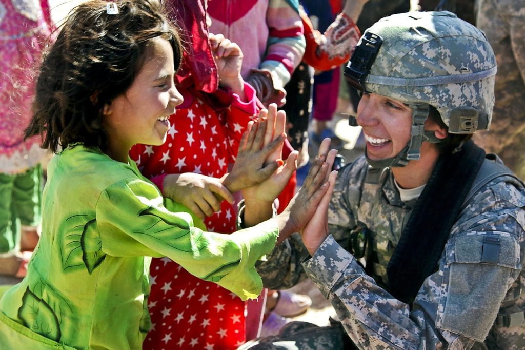 Woman veteran playing with little girl