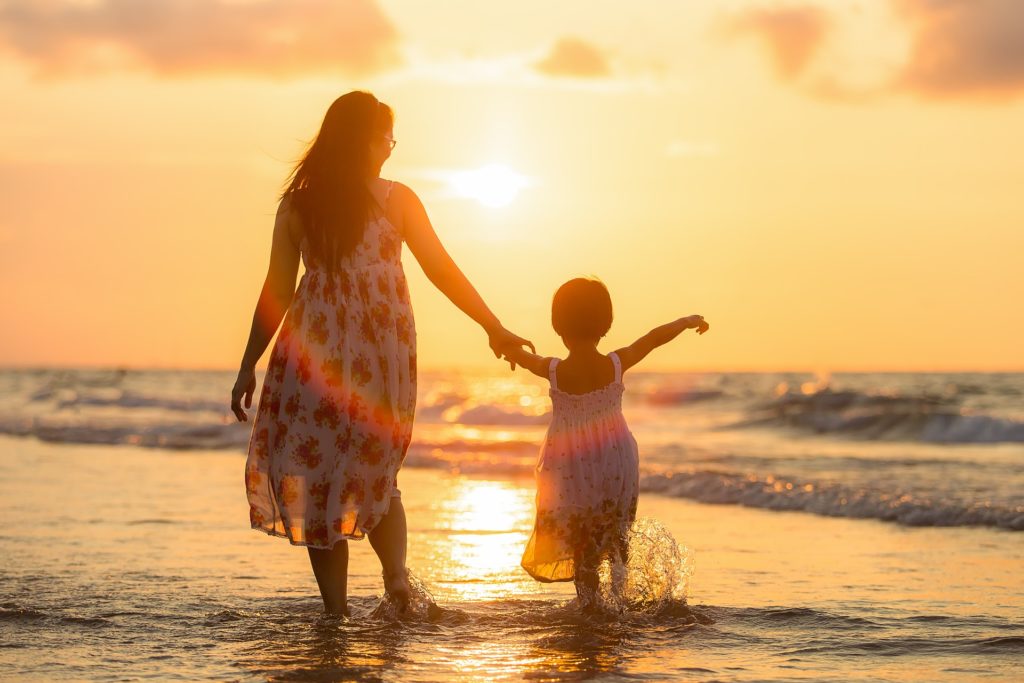 Parent and youth on beach