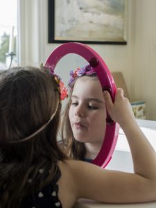 Girl looking in mirror