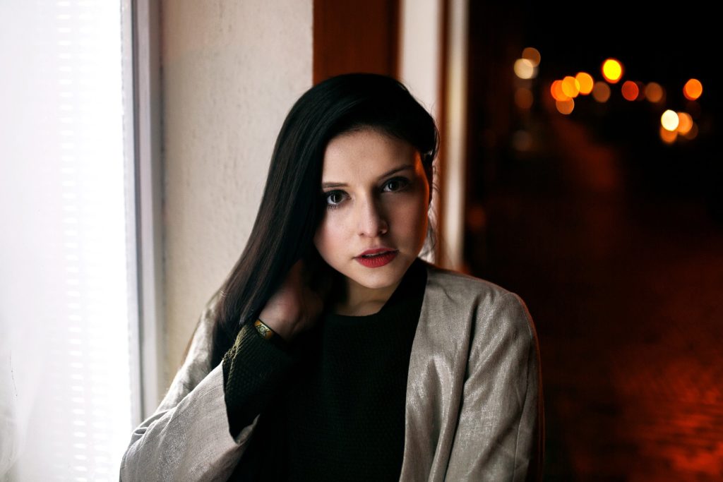 Woman standing before window