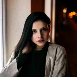 Woman standing before window