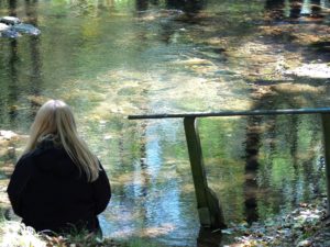 Woman by the river thinking about Health at Every Size