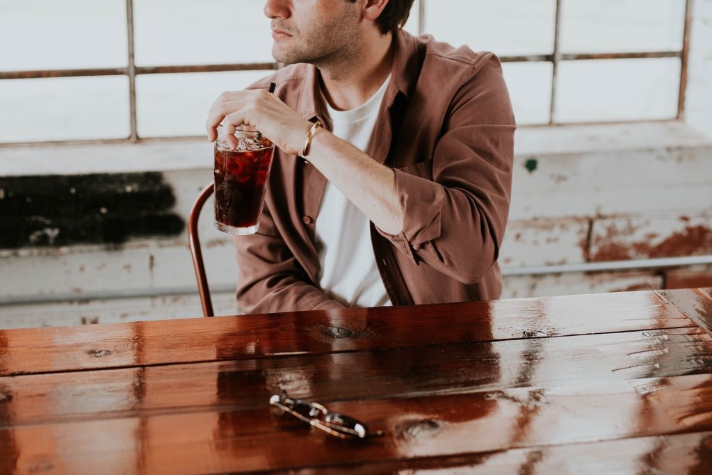 Man drinking sugar-sweetened beverages