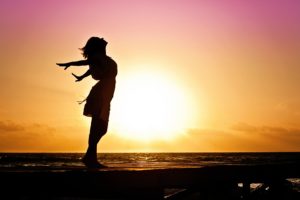 Woman standing in the sunset