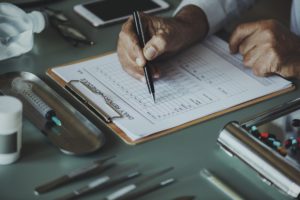 Doctor filling out form for binge eating treatment