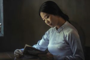 Asian American Woman or Girl Reading a Book