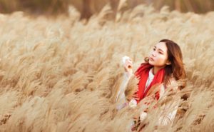 Asian American Woman in Wheat Field self-soothing
