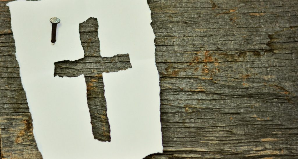 Cross tacked on a piece of wood