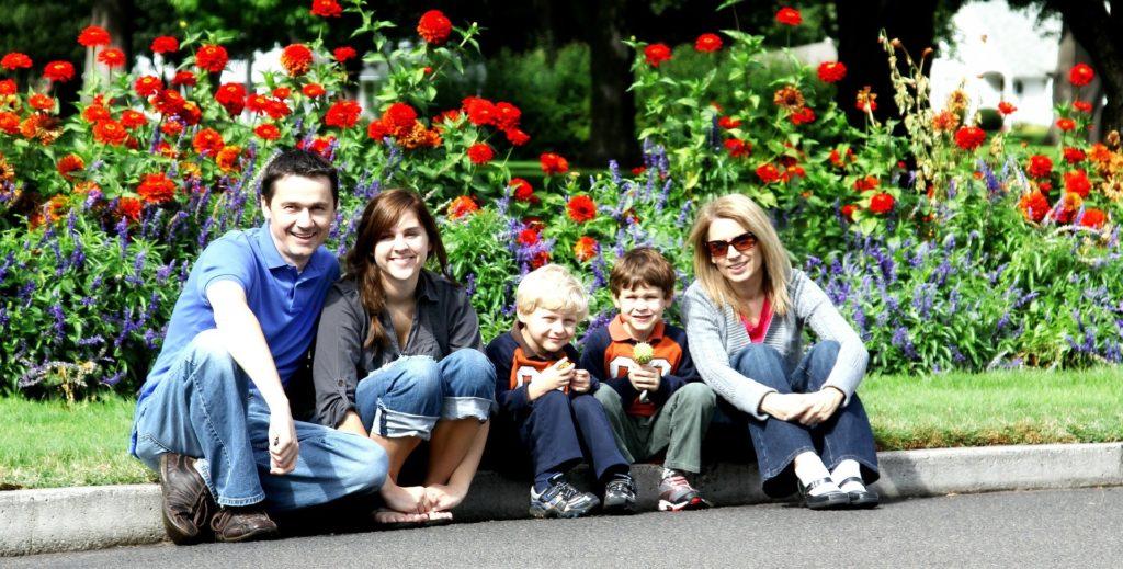 Family Sitting On Curb