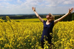 Lady in field experiencing feelings in eating disorder recovery
