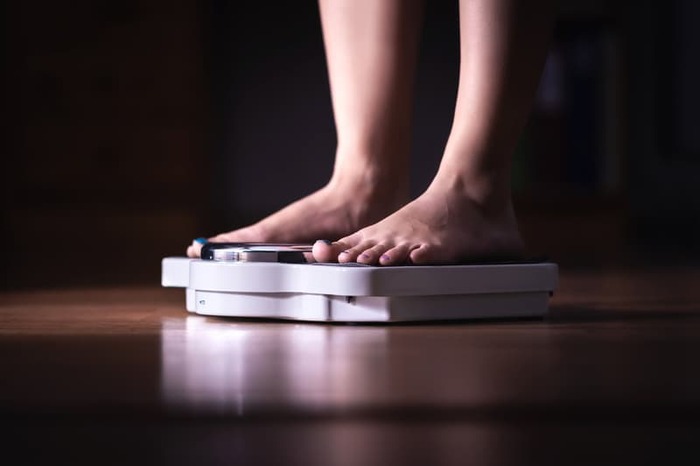 Women Weighing Herself