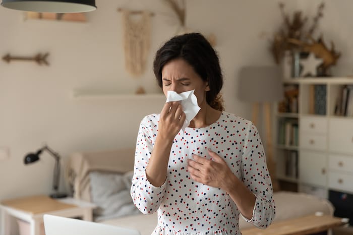 woman blowing nose