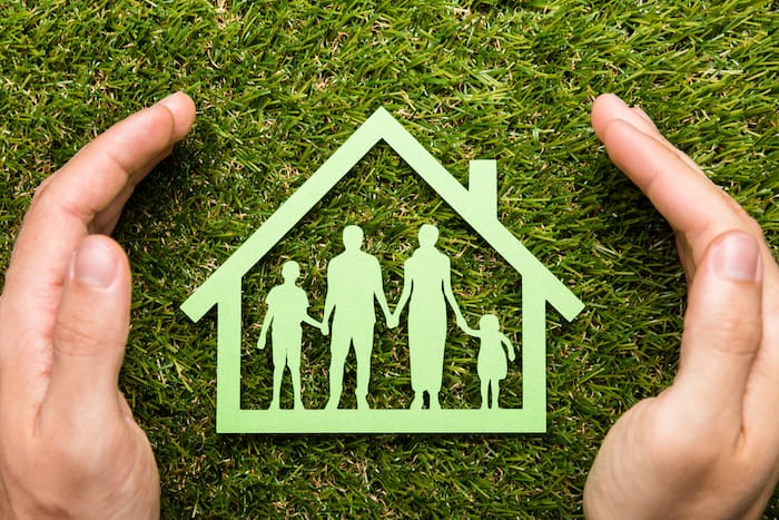 paper cutout of a family in a house 