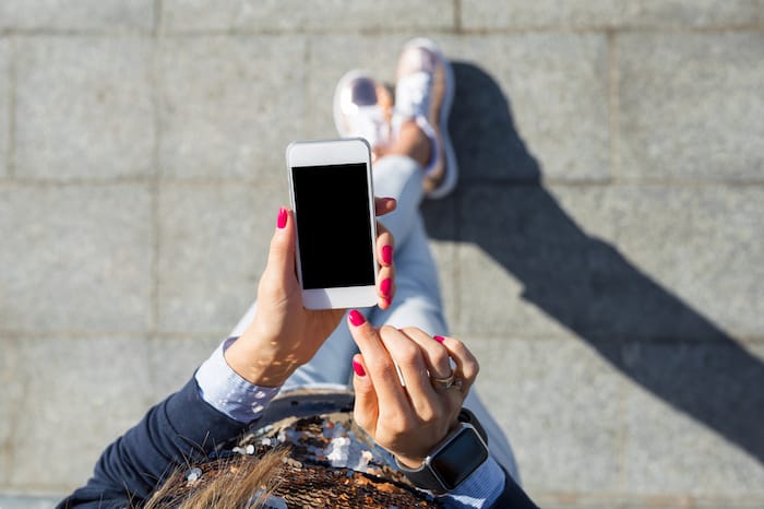 woman with phone in hand