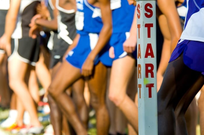 boy cross country runners at the start line