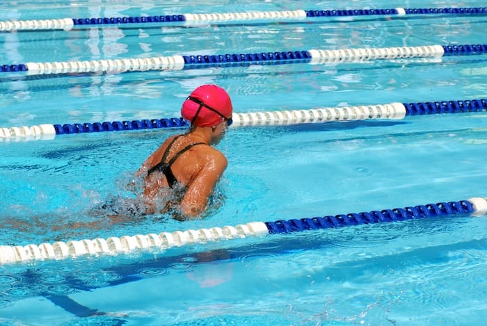 woman swimming laps in a pool